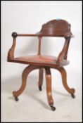 A Victorian mahogany and leather swivel chair rais