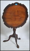 A Victorian mahogany tilt top wine table having sc