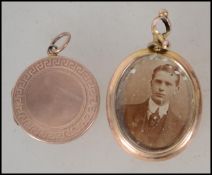 A heart shaped hinged 9ct gold locket together with another 9ct gold locket.