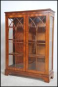 A Regency style yew wood astragal glazed library b