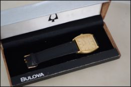 A cased vintage 1970's Bulova gentlemans wristwatch set in a gilt metal case with leather strap in