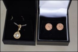 A pair of silver ball stud earrings together with a silver and Swarovski crystal teardrop pendant
