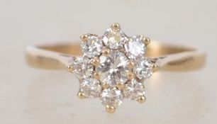 A 9ct gold and diamond flower head cluster ring approx 50pnts in total. Weight 1.6g / Size L