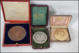 A group of three boxed medallion coins to include a Queen Victoria diamond Jubilee medal 1837-97 a