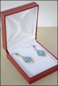 A pair of marcasite and blue opal drop earrings. 4