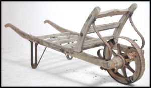 A vintage early 20th century single wheel wooden s
