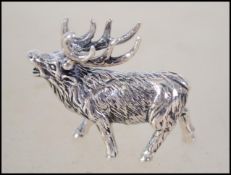 A silver figure of a stag marked sterling.