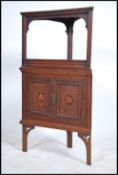 An Edwardian Arts and crafts oak two tiered inlaid