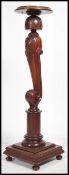 A stunning Regency mahogany carved torchere. On a