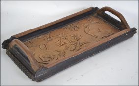 A 19th century carved in relief oak tray. Carved i