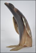 A vintage mid century horn carved figurine of a pe