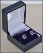 A pair of ladies silver and amethyst stud earrings