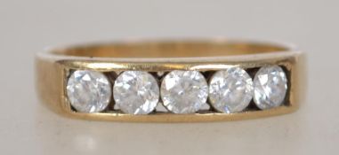 A 9ct gold 5 stone diamond ring being channel set