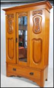 An Edwardian Art Nouveau walnut single wardrobe ha