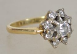 An 18ct gold and diamond ring having starburst mou