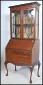 An Edwardian mahogany inlaid bureau bookcase cabin