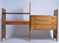 A Staples Ladderax teak sectional shelving system, with wooden slatted uprights, comprising of two