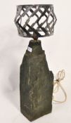 A large heavy stone and cut polished steel table lamp. Heavy stone fragment base with applied bulb