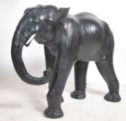 A large floorstanding leather elephant originally retailed by Maples & Co of London. Glass eyes with
