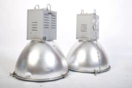 A pair of 20th century Industrial Hillclare factory pendant lights having half sphere polished