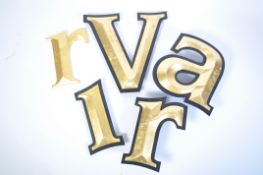 A collection of vintage external wall advertising letters / lettering being resin cast black with