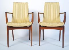A stunning pair of 1960's rosewood carver armchairs. Raised on tapered legs with angular upholstered