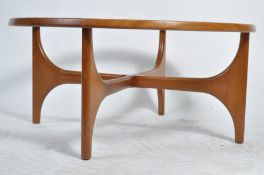 A retro mid century teak wood circular atomic style coffee table raised on shaped angular supports
