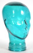 An unusual 20th century teal coloured glass head - bust used for shop display Haberdashery stand.