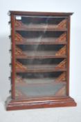 A stunning late 19th / early 20th century shop cabinet with glass facia having multiple sliding