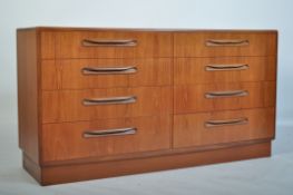 A 1970's G-Plan teak wood Kelso Pattern double chest of drawers being raised on an inset plinth with