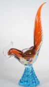 A mid century glass studio art sculpture of a cockerel having a tapered blue glass base, the bird