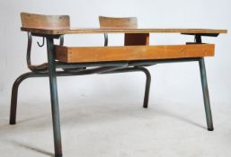 A large retro double school desk of French origin having tubular metal frame with slatted seat and