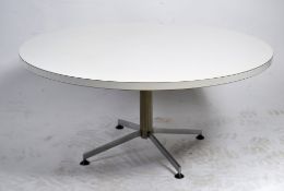 A 1960's white laminate circular coffee table in the manner of Arkana raised on a chrome support.