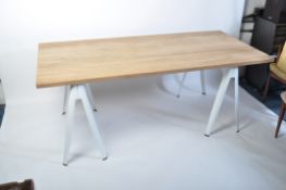 A post modernist revival large refectory trestle dining table. Raised on tolix style white metal