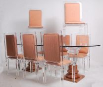 A large Philippe Starck manner table and chairs. The dining chairs of resin construction having