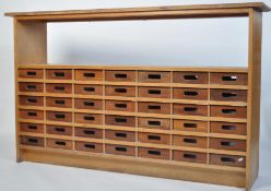 A mid century Industrial two tone wooden office cabinet - chest of drawers having a series of 42