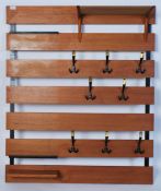 A mid century retro teak wood slatted modular wall coat rack stand. The seven teak wood slats having