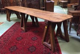 An exceptional large trestle table of oak form having oversized 3 trestle supports having a very