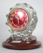 An unusual mid century retro Russian mantel clock. The red dial with cyrillic writing set within cut