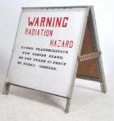 An unusual mid century / 1960's A-frame painted metal radiation sign with further notation in red