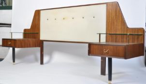 A retro 20th century G-Plan Librenza headboard with built-in side drawers and glass shelves raised