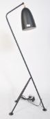 After Greta Grossman, a large black grasshopper floor lamp. Having a tubular steel tripod frame with