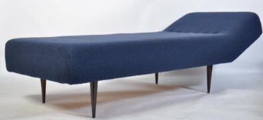 A retro 20th century sofa day bed of large form being raised on angular tapering legs and