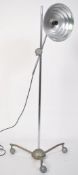 A vintage mid century floor standing adjustable converted heat lamp, having a metal tubular