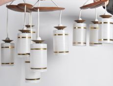 A set of three triple drop ceiling lights.  These vintage lamps have opaque glass shades hanging