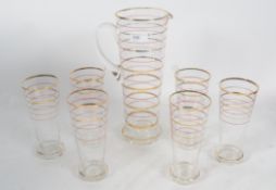 1930's Lemonade set. Tall jug with 6 highball glass decorated with gold leaf rings and red rings