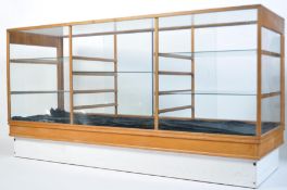 An early 20th century large Industrial Haberdashery shop display cabinet being raised on a white