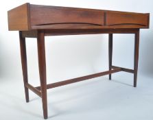 A 1960's teak writing table desk in the manner of Archie Shine for Robert Heritage. The table on