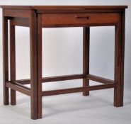 A 1960's unusual G-Plan teak wood nest of tables raised on squared legs with the twin small nests