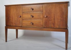 An original mid century Gordon Russell walnut sideboard / dresser. Raised on squared legs with a